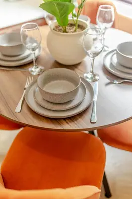 a wooden table with plates and wine glasses on it at Cosy city centre home - Wi-Fi - Free Parking in Preston