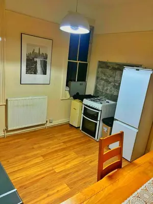 a kitchen with a refrigerator and a stove at Near City-Birkenhead rooms in Birkenhead