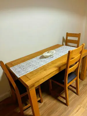a wooden table with two chairs and a table with at Near City-Birkenhead rooms in Birkenhead