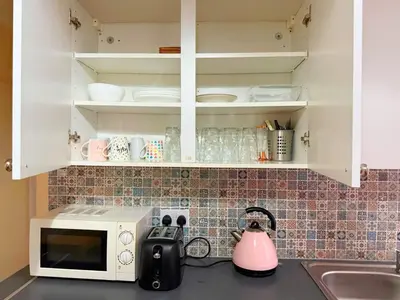a kitchen counter with a sink and a microwave at Near City-Birkenhead rooms in Birkenhead