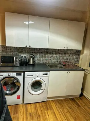 a kitchen with a washing machine and a sink at Near City-Birkenhead rooms in Birkenhead