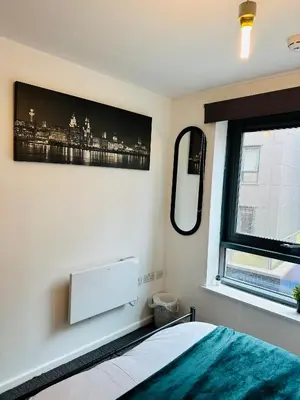 a bedroom with a bed and a window at Longterm Stay City Centre Apartment 2 Bedrooms in Liverpool
