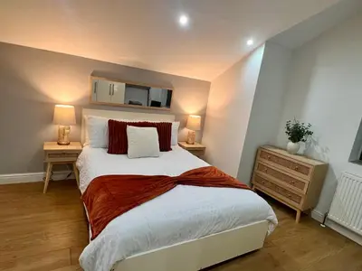 a bedroom with a large bed and two night stands at New Modern 3 Bed En-suites City Centre Apartment - Sleeps 8- Paid Parking Options in Preston