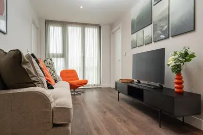a living room with a couch and a flat screen tv at River Mersey Views Modern 2-Bed Waterfront Flat Near Albert Dock in Liverpool