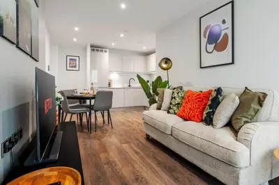 a living room with a couch and a table at River Mersey Views Modern 2-Bed Waterfront Flat Near Albert Dock in Liverpool