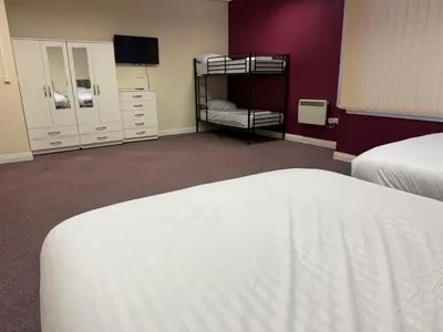 a bedroom with two bunk beds and a tv at Art Group Apartments in Fleetwood