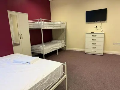 a bedroom with a bunk bed and a television at Art Group Apartments in Fleetwood
