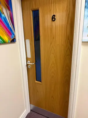 a wooden door with the number six on it at Art Group Apartments in Fleetwood
