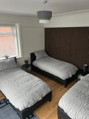 a room with two beds and a window at Cosy Apartment in Wallasey Village Near Liverpool in Wallasey