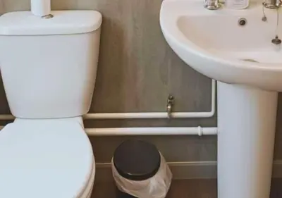 a bathroom with a white toilet and a sink at Pitchside Place Walk to Anfield sleeps 19 in Liverpool