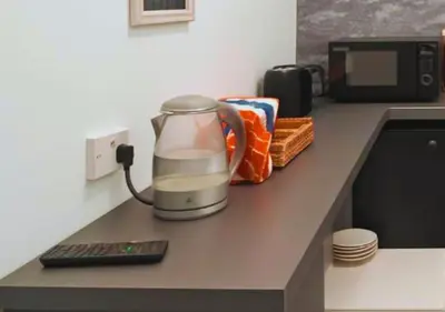 a blender sitting on a counter next to a microwave at Pitchside Place Walk to Anfield sleeps 19 in Liverpool