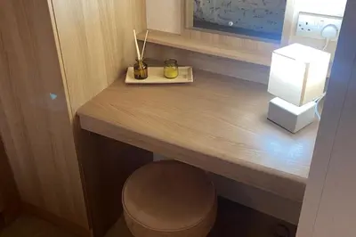 a desk in a room with a lamp on it at 2 Bed Caravan-Sleeps 6-Pet Friendly in Carnforth