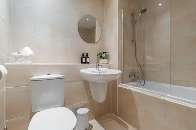 a bathroom with a toilet and a sink and a shower at Spacious City Stay 2BR 2BA Parking Included in Liverpool
