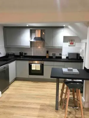 a kitchen with a table and a counter top at 2 Bedroom City Centre Georgian Quarter Apartment in Liverpool