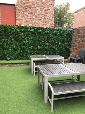 three picnic tables and chairs on a lawn with flowers at 2 Bedroom City Centre Georgian Quarter Apartment in Liverpool