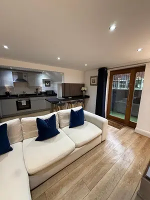a white couch with blue pillows in a living room at 2 Bedroom City Centre Georgian Quarter Apartment in Liverpool