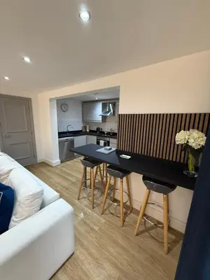 a living room with a couch and a table with chairs at 2 Bedroom City Centre Georgian Quarter Apartment in Liverpool