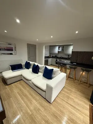 a living room with a white couch and a piano at 2 Bedroom City Centre Georgian Quarter Apartment in Liverpool