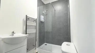 a bathroom with a shower and a sink and a toilet at Three Bedroom House in Wigan - Perfect for family! in Ince-in-Makerfield