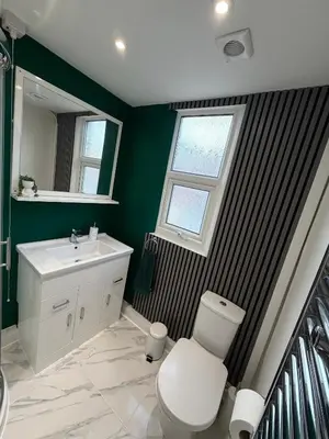 a bathroom with a toilet and a sink and a window at D&D Emerald House Anfield in Liverpool