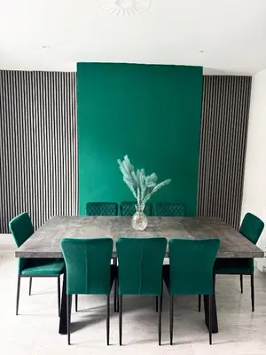 a dining room with a table and green chairs at D&D Emerald House Anfield in Liverpool