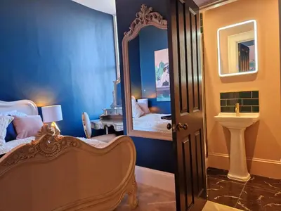 a bedroom with a mirror and a bed and a sink at Hamilton - The Hyde Luxury Let in Preston