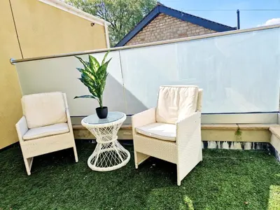 two chairs and a table and a potted plant on a balcony at Hamilton - The Hyde Luxury Let in Preston