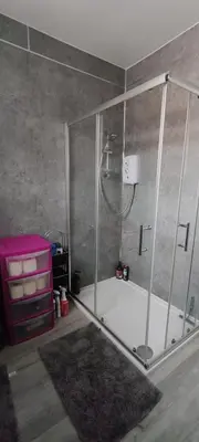 a bathroom with a shower and a bath tub at Quality Rooms in Liverpool