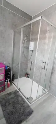 a shower with a glass enclosure in a bathroom at Quality Rooms in Liverpool