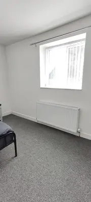 an empty room with a window and a radiator at Quality Rooms in Liverpool