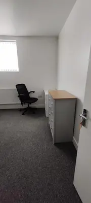 an empty office with a desk and a chair at Quality Rooms in Liverpool