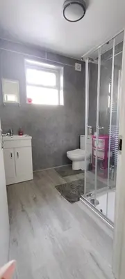 a bathroom with a shower and a toilet in it at Quality Rooms in Liverpool