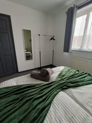 a bedroom with a bed with a green blanket on it at #72 Stylish 3 bedroom sleeps 7 Wigan House in Pemberton