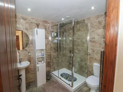 a bathroom with a shower and a toilet at Pompian Lodge in Leyland