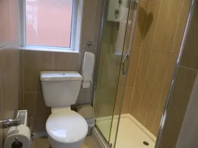 a bathroom with a toilet and a glass shower at Blackpool San Remo Bungalows 9 & 10 in Blackpool