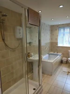 a bathroom with a tub and a sink at Blackpool San Remo Bungalows 9 & 10 in Blackpool