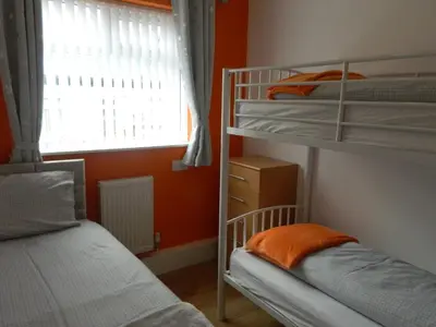 two bunk beds in a room with a window at Blackpool San Remo Bungalows 9 & 10 in Blackpool