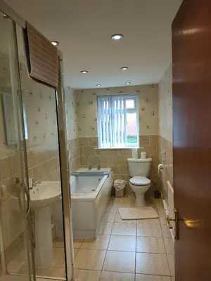 a bathroom with a tub and a toilet and a sink at Blackpool San Remo Bungalows 9 & 10 in Blackpool