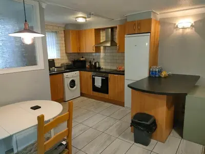 a kitchen with a white refrigerator and a table at Blackpool San Remo Bungalows 9 & 10 in Blackpool