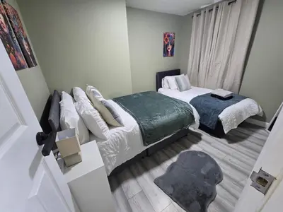 a small bedroom with two beds and a window at House 5 Minutes from Sefton Park in Liverpool