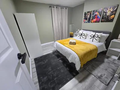 a bedroom with a bed with a yellow blanket at House 5 Minutes from Sefton Park in Liverpool