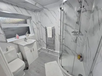 a bathroom with a shower and a toilet and a sink at Room 1 Shared house 5 min from Sefton Park in Liverpool