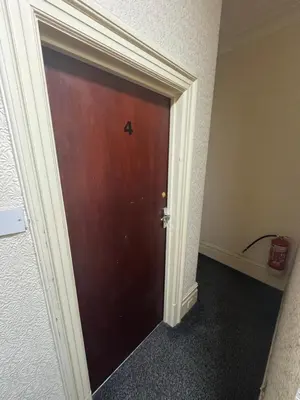 a brown door in a room with at Snug Studio - Minutes Walking from Pleasure Beach - Burlington Road in Blackpool