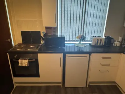 a kitchen with a stove and a counter top at Snug Studio - Minutes Walking from Pleasure Beach - Burlington Road in Blackpool