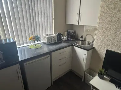 a small kitchen with a sink and a counter top at Snug Studio - Minutes Walking from Pleasure Beach - Burlington Road in Blackpool