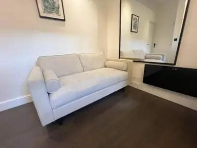 a living room with a white couch and a tv at Liverpool Jasmine House - Spacious 2-Bed Near Anfield Stadium in Liverpool