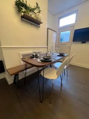 a dining room with a table and chairs and a window at Liverpool Jasmine House - Spacious 2-Bed Near Anfield Stadium in Liverpool