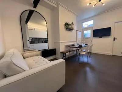 a living room with a white couch and a table at Liverpool Jasmine House - Spacious 2-Bed Near Anfield Stadium in Liverpool