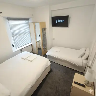 a hotel room with two beds and a sign that reads justice at Jubilee holiday flats in Blackpool