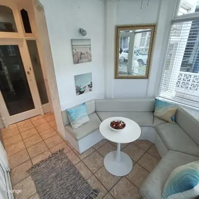 a living room with a couch and a table at Jubilee holiday flats in Blackpool